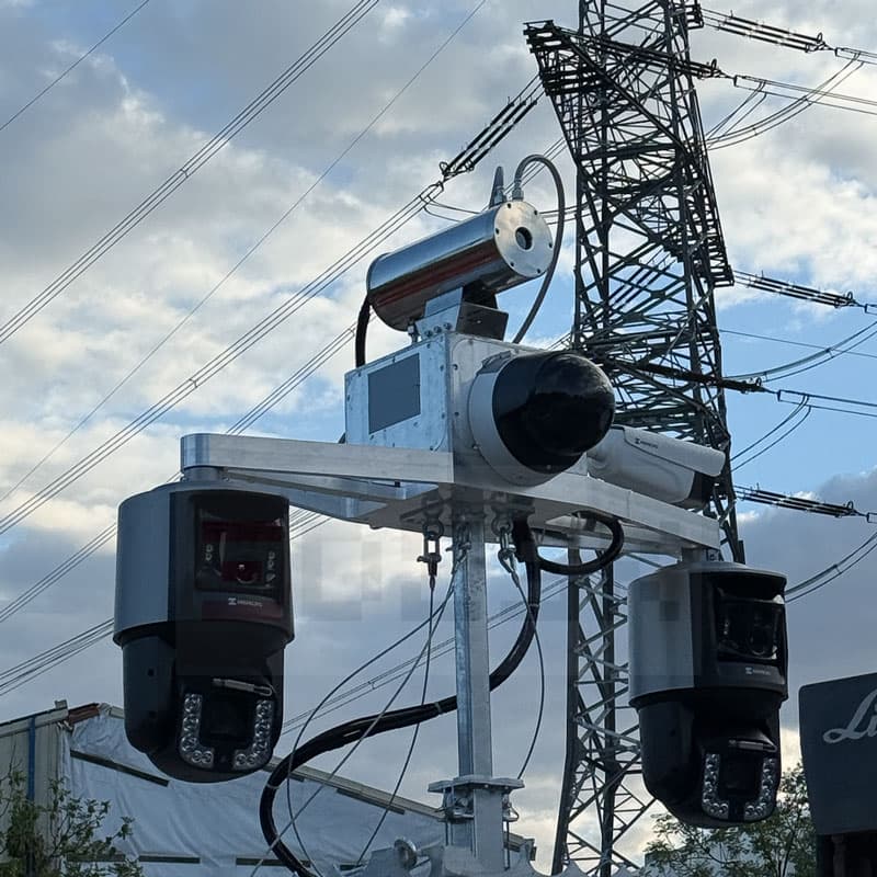 Kameratechnik auf einem Überwachungsmast vor einem Strommast